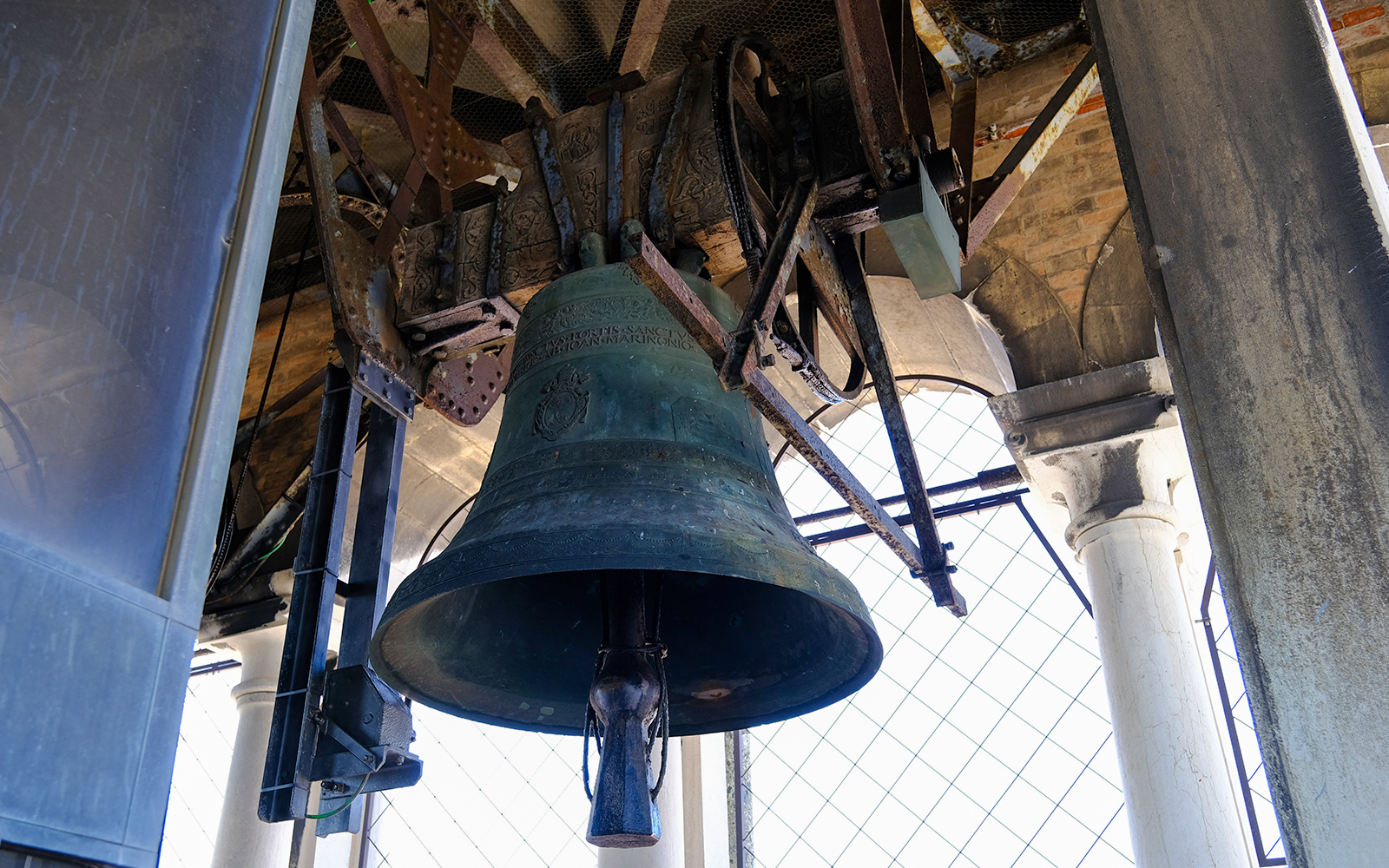 St Mark's Campanile bell tower in Venice, Italy, with blue sky background.