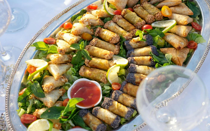 Traditional Moroccan appetizers on a platter with dipping sauce at Agadir's Fantazia Berber Night Show.