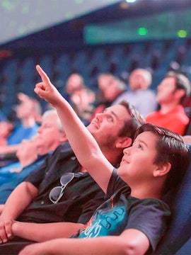 Child pointing at planetarium display in San Diego.