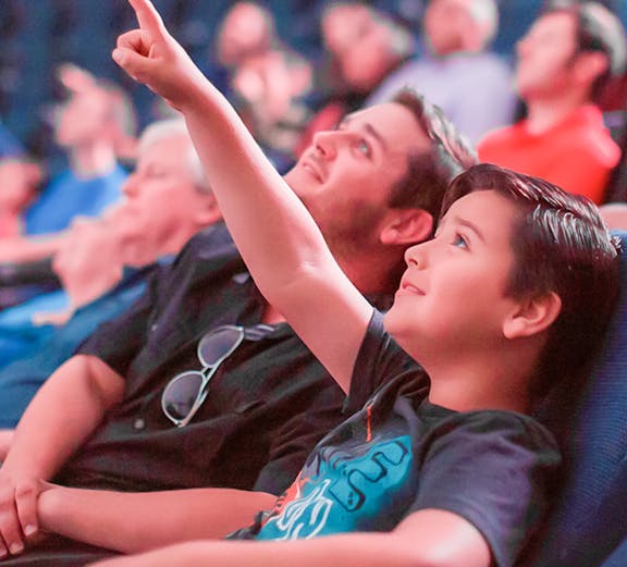 Child pointing at planetarium display in San Diego.