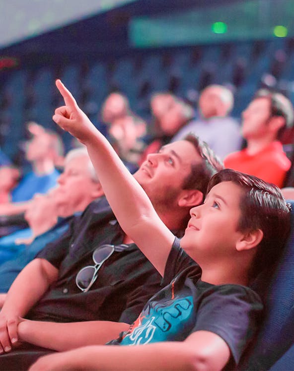 Child pointing at planetarium display in San Diego.