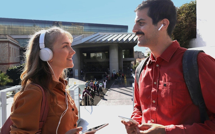 Visitors with audio guides outside Acropolis Museum, Athens.