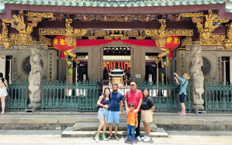 Family posing in front of Thian Hock Keng Temple during Singapore City Tour.