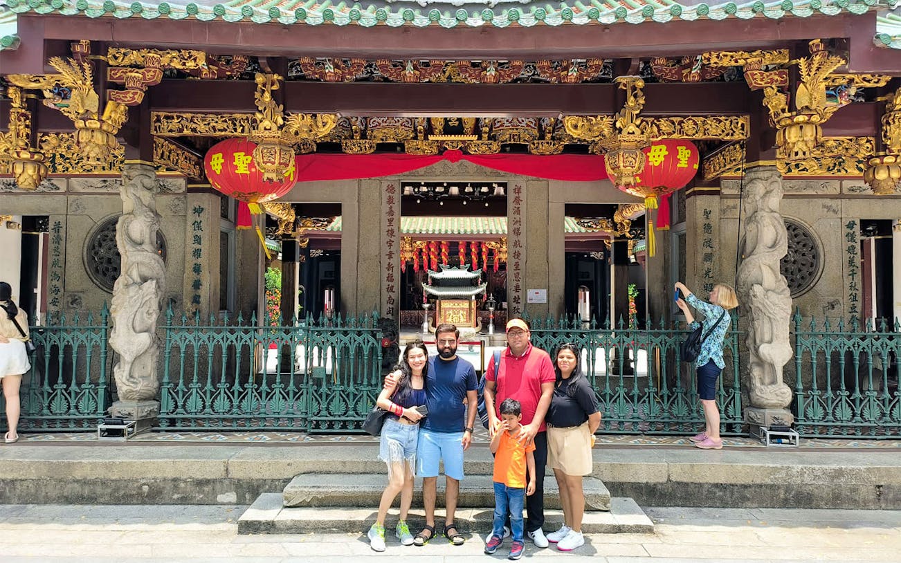 Family posing in front of Thian Hock Keng Temple during Singapore City Tour.