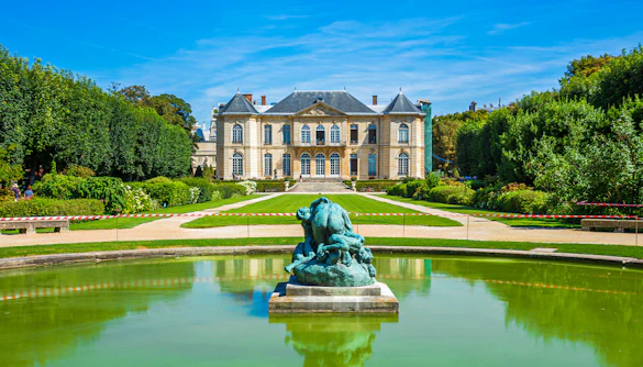 Rodin Museum gardens with sculpture and historic building in Paris.