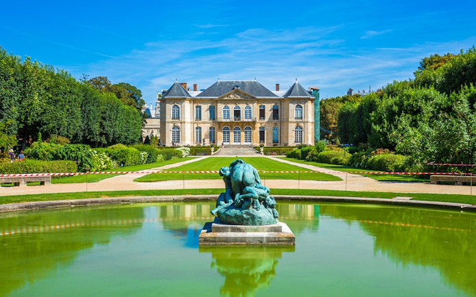 Rodin Museum gardens with sculpture and historic building in Paris.