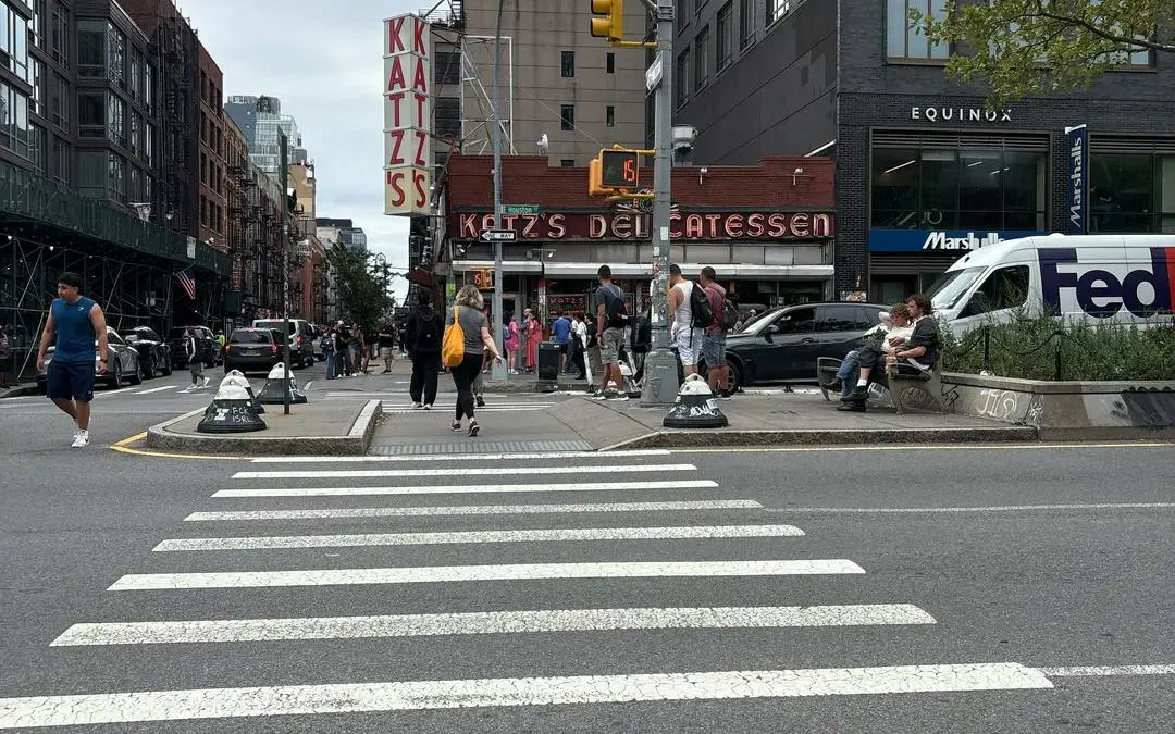 Katz's Delicatessen exterior on a busy New York street, part of Broadway Whodunit game.