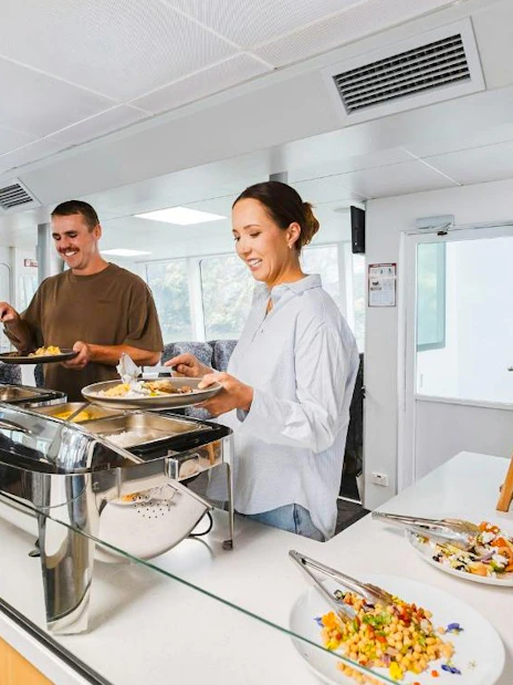 Couple enjoying buffet on Milford Sound VIP cruise from Queenstown.