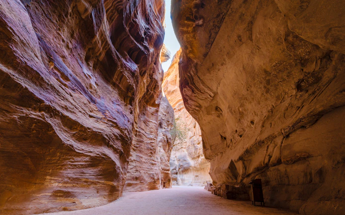 Sandstone walls of the Siq canyon in Petra, Jordan, leading to ancient city.