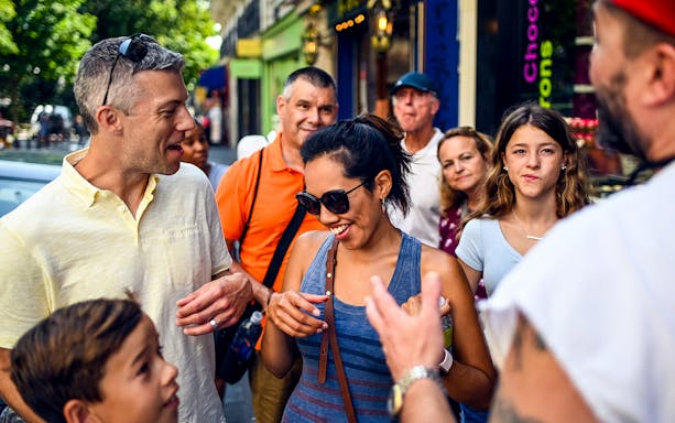 Group enjoying a guided food tour in Montmartre, Paris.