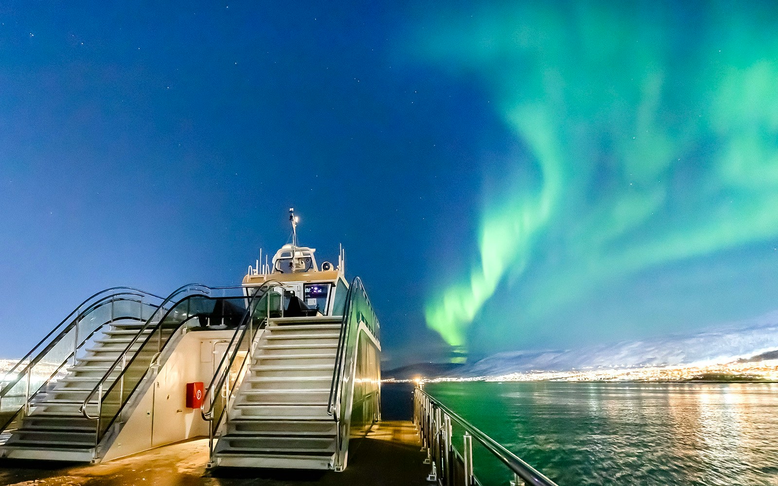 Cruise ship under Northern Lights in Tromso, Norway.