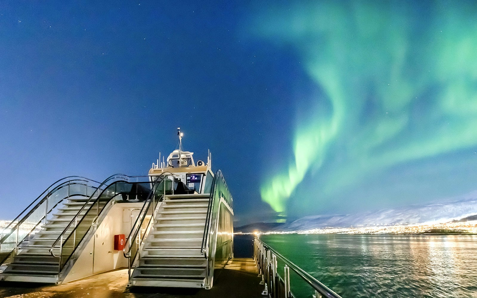 Cruise ship under Northern Lights in Tromso, Norway.