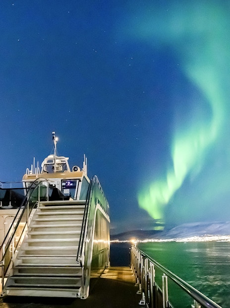 Cruise ship under Northern Lights in Tromso, Norway.