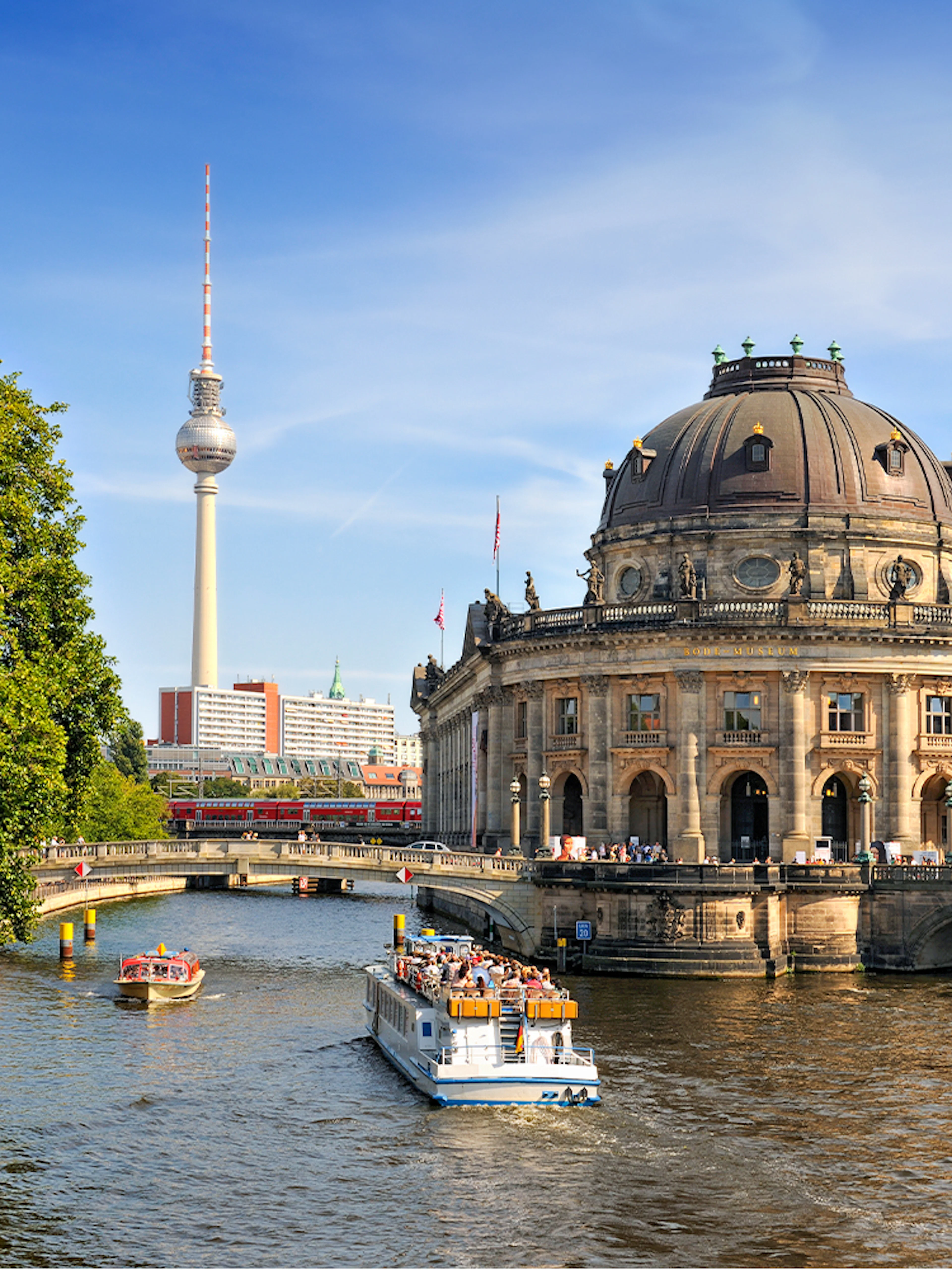 Spree river cruise passing Museum Island with Berlin TV Tower in the background.