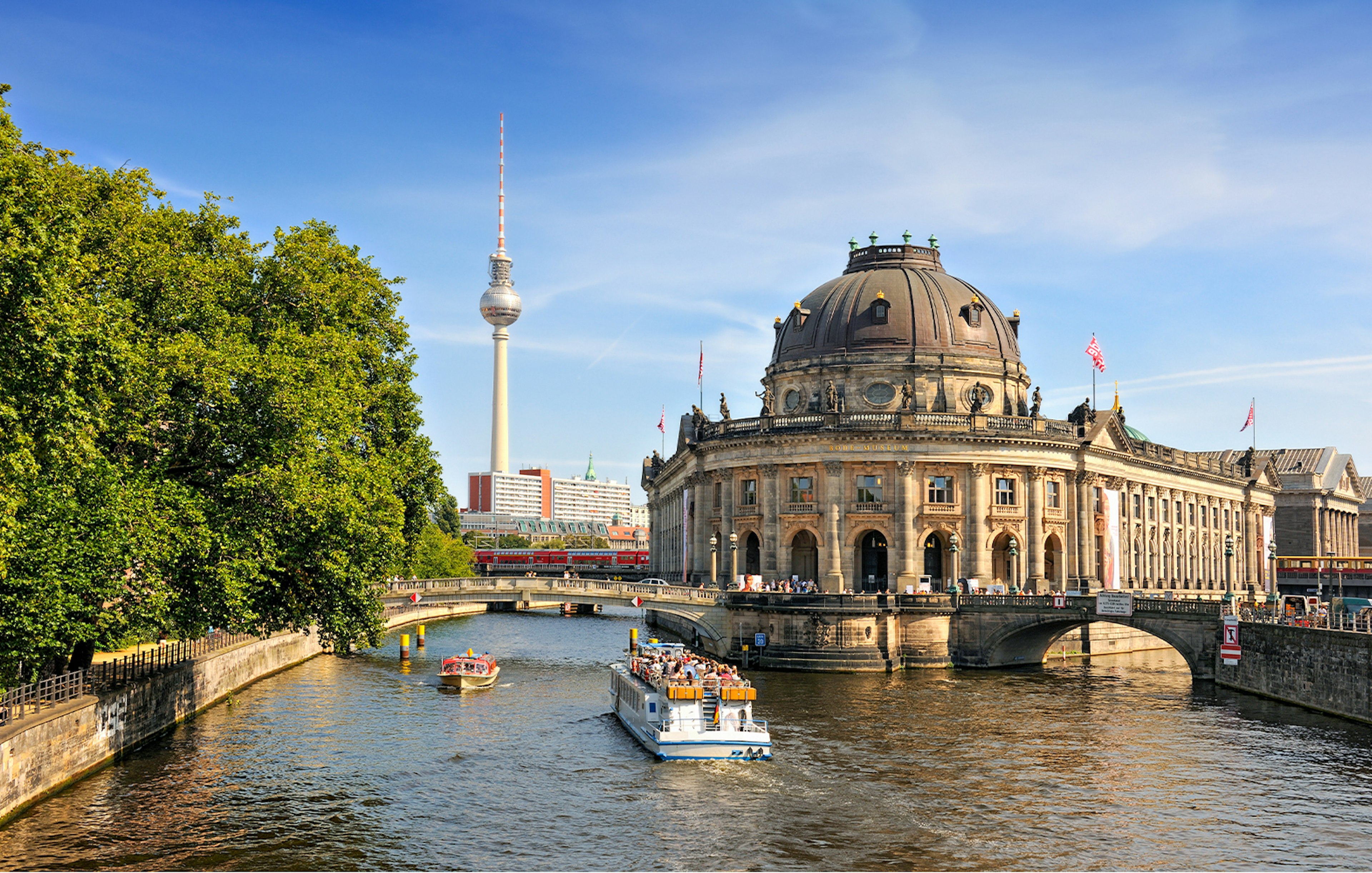 Spree river cruise passing Museum Island with Berlin TV Tower in the background.