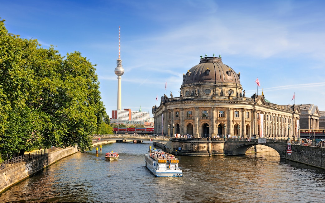 Spree river cruise passing Museum Island with Berlin TV Tower in the background.