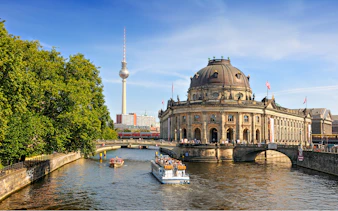 Spree river cruise passing Museum Island with Berlin TV Tower in the background.