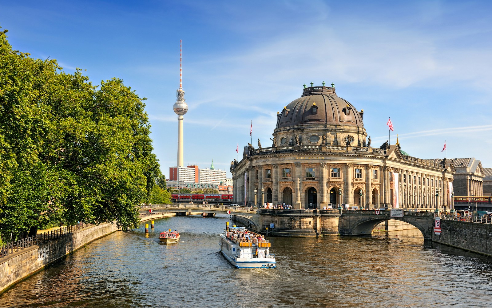 Spree river cruise passing Museum Island with Berlin TV Tower in the background.