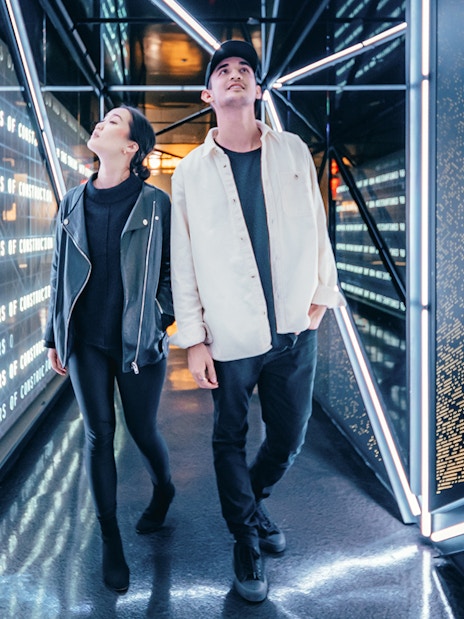 Visitors walking through a futuristic corridor at Edge, New York City.