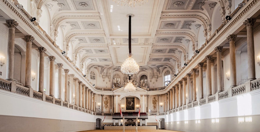 Spanish Riding School arena interior, Vienna, with chandeliers and ornate architecture.
