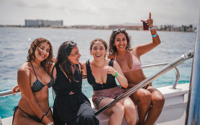 Tourists enjoying Cruise Crush Boat Party on the ocean.