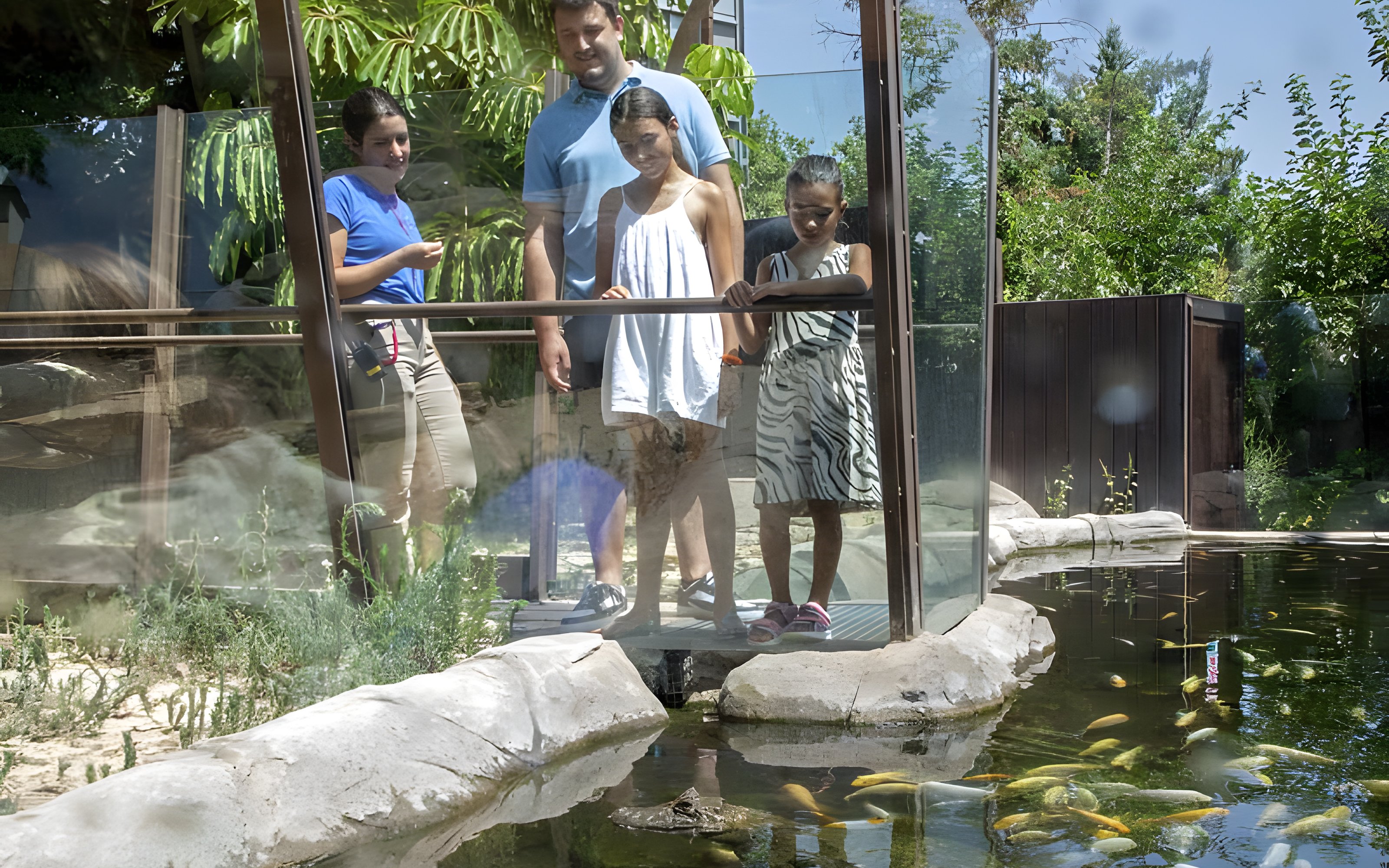 Visitors observing fish at Selwo Marina Park, Spain.