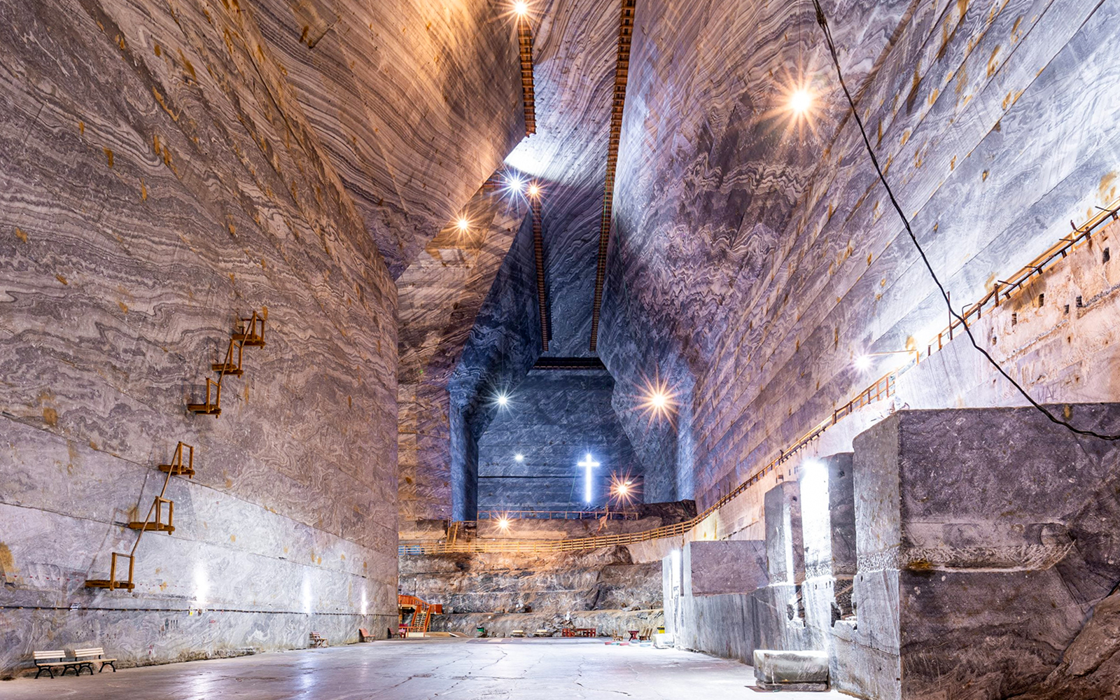 Guests exploring the vast chambers of Slanic Salt Mine, Romania.