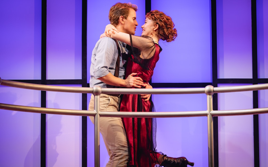 Actors embrace on stage during Titanique Westend performance.