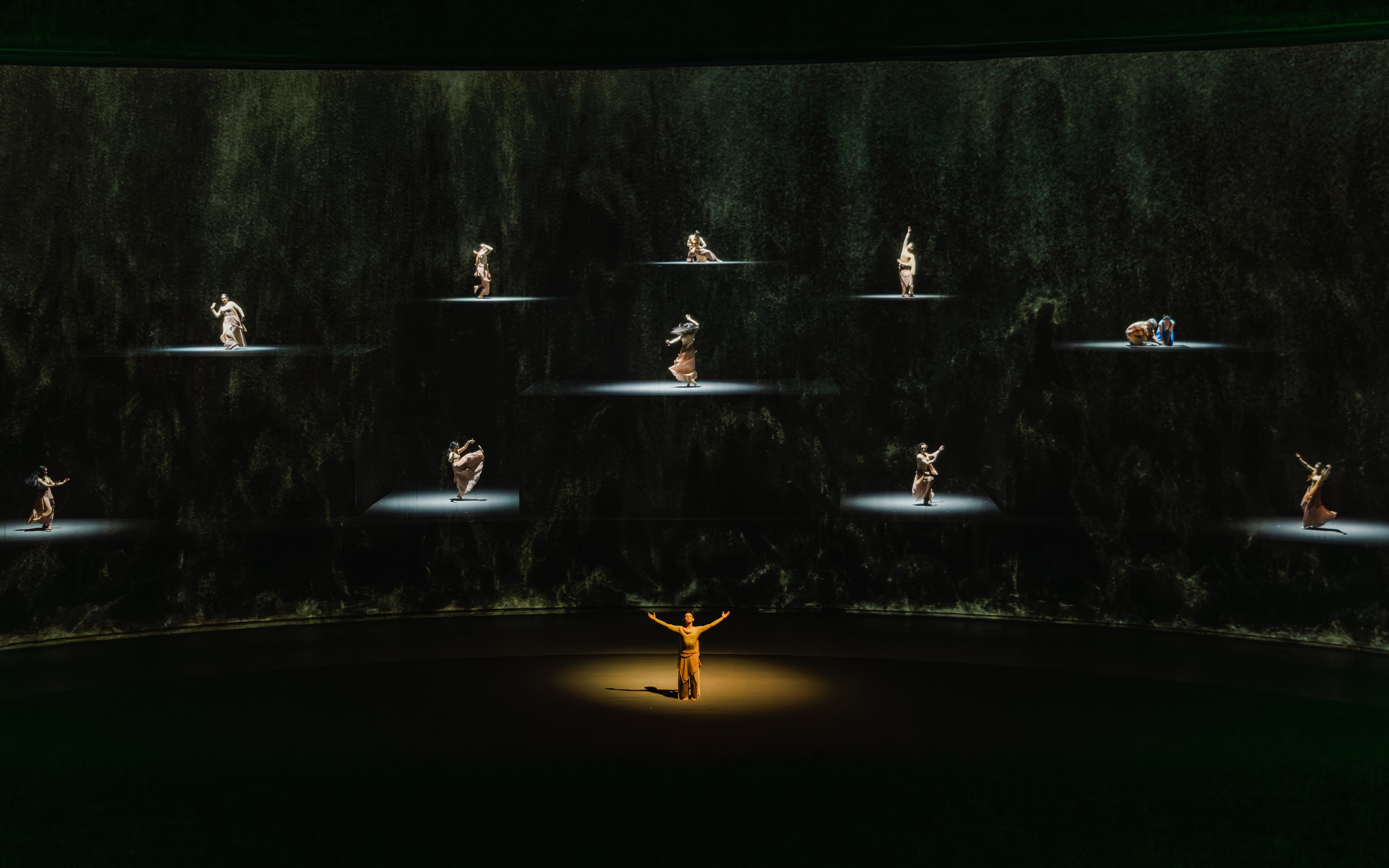 Performers on stage in "The Legacy of a Generation Show" with spotlighted dancers.