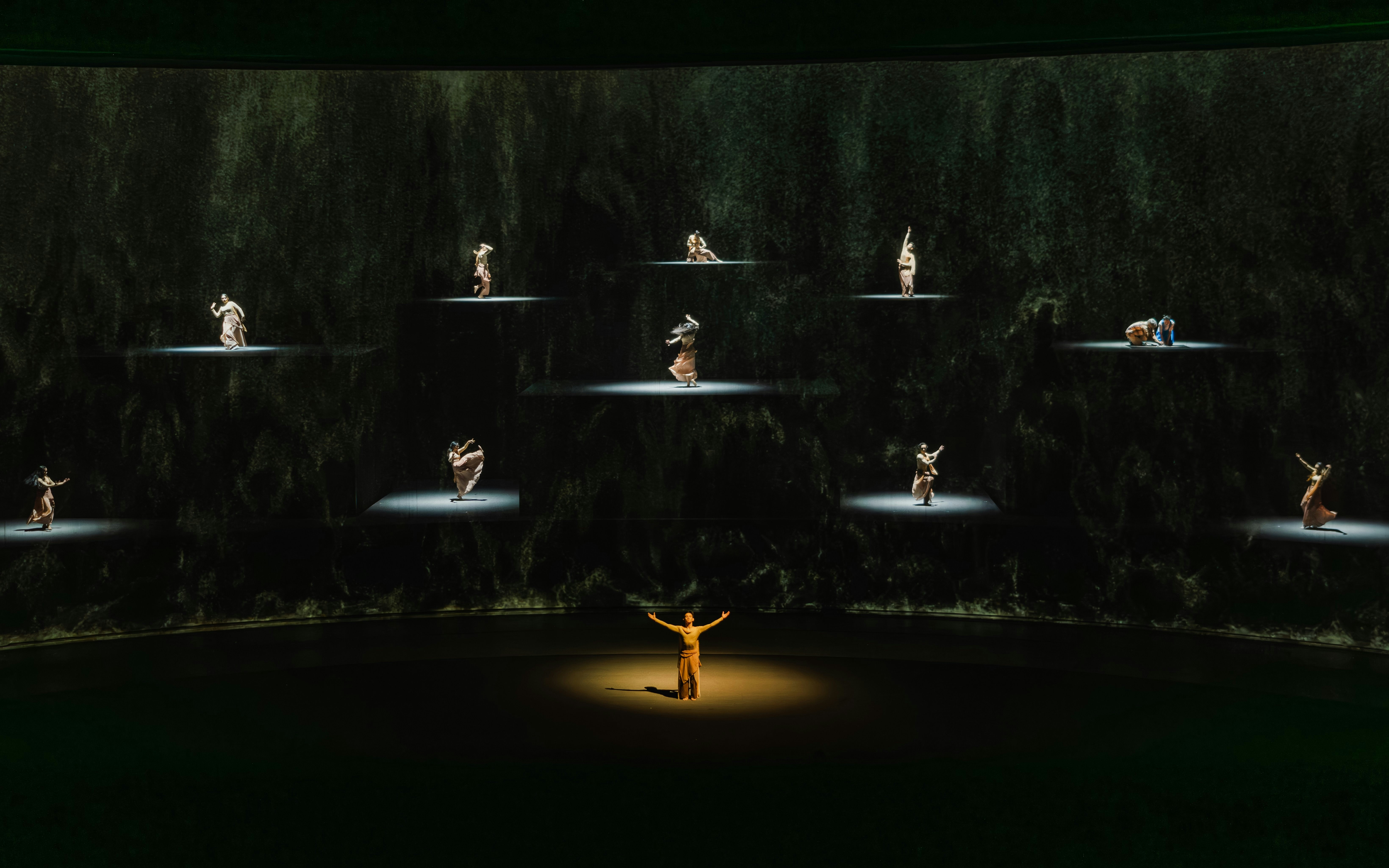 Performers on stage in "The Legacy of a Generation Show" with spotlighted dancers.