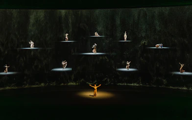 Performers on stage in "The Legacy of a Generation Show" with spotlighted dancers.