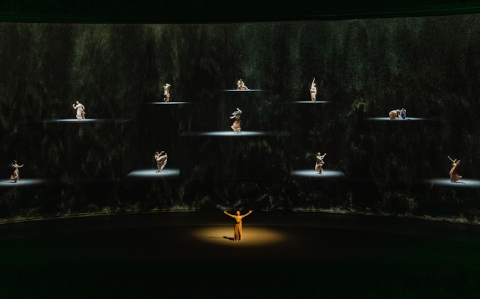 Performers on stage in "The Legacy of a Generation Show" with spotlighted dancers.