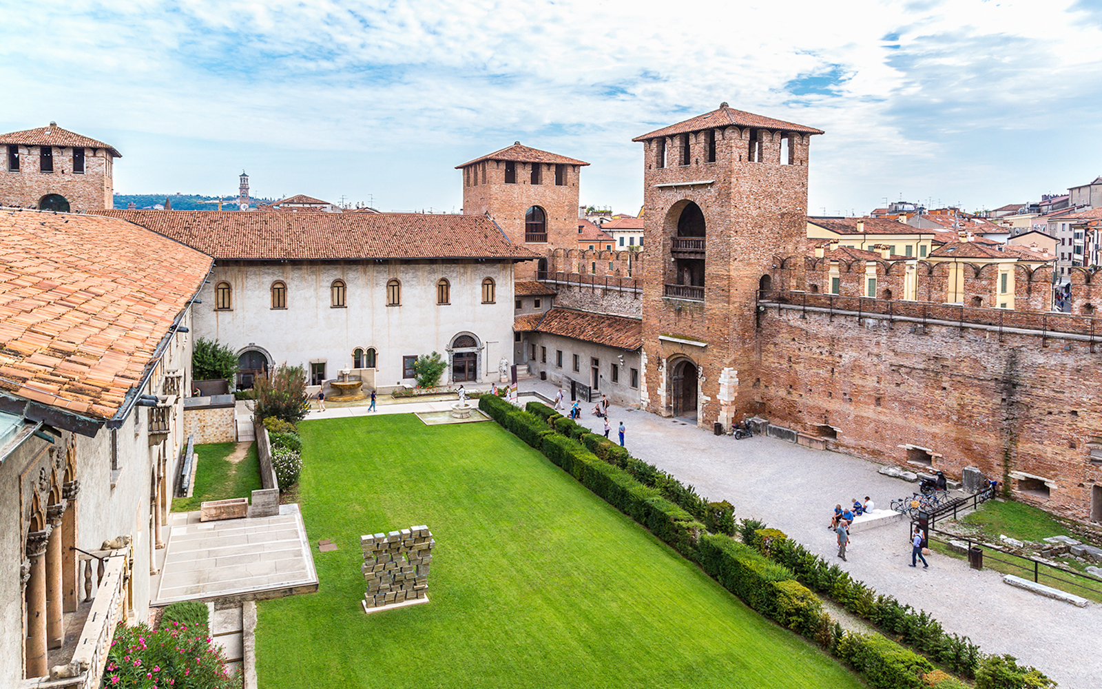 Castelvecchio Museum courtyard with historic walls and green lawn in Verona.