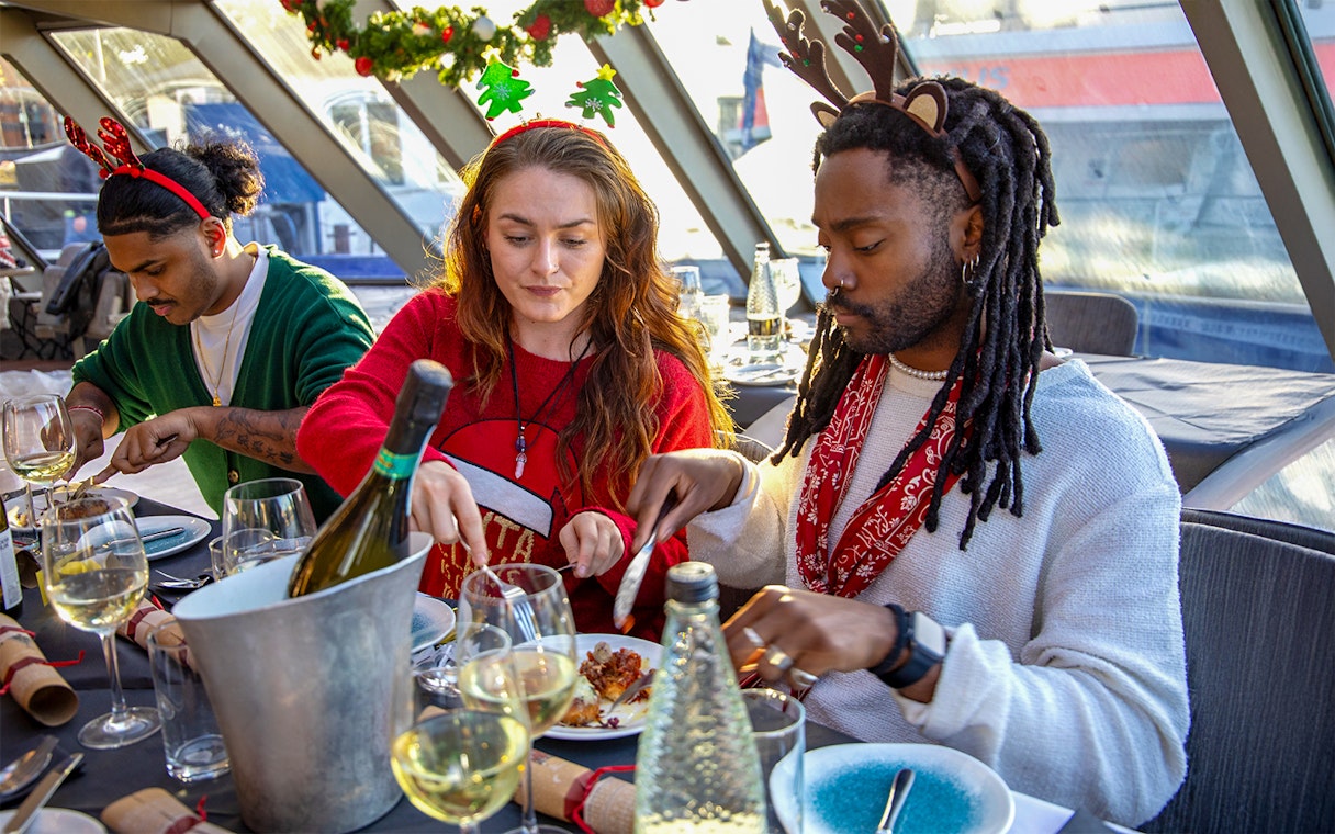 Guests enjoying Christmas lunch on a Thames River cruise.