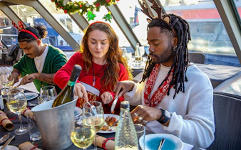 Guests enjoying Christmas lunch on a Thames River cruise.