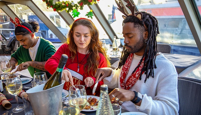 Guests enjoying Christmas lunch on a Thames River cruise.