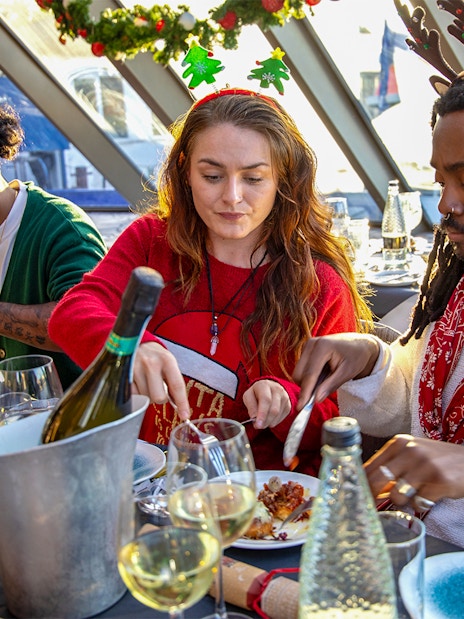 Guests enjoying Christmas lunch on a Thames River cruise.