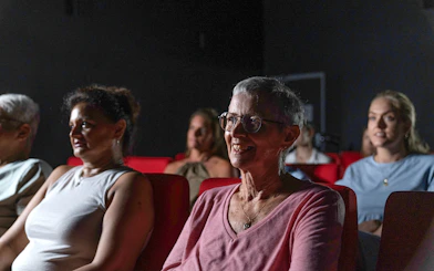 Visitors seated in a theater at the Darwin Royal Flying Doctor Service experience.