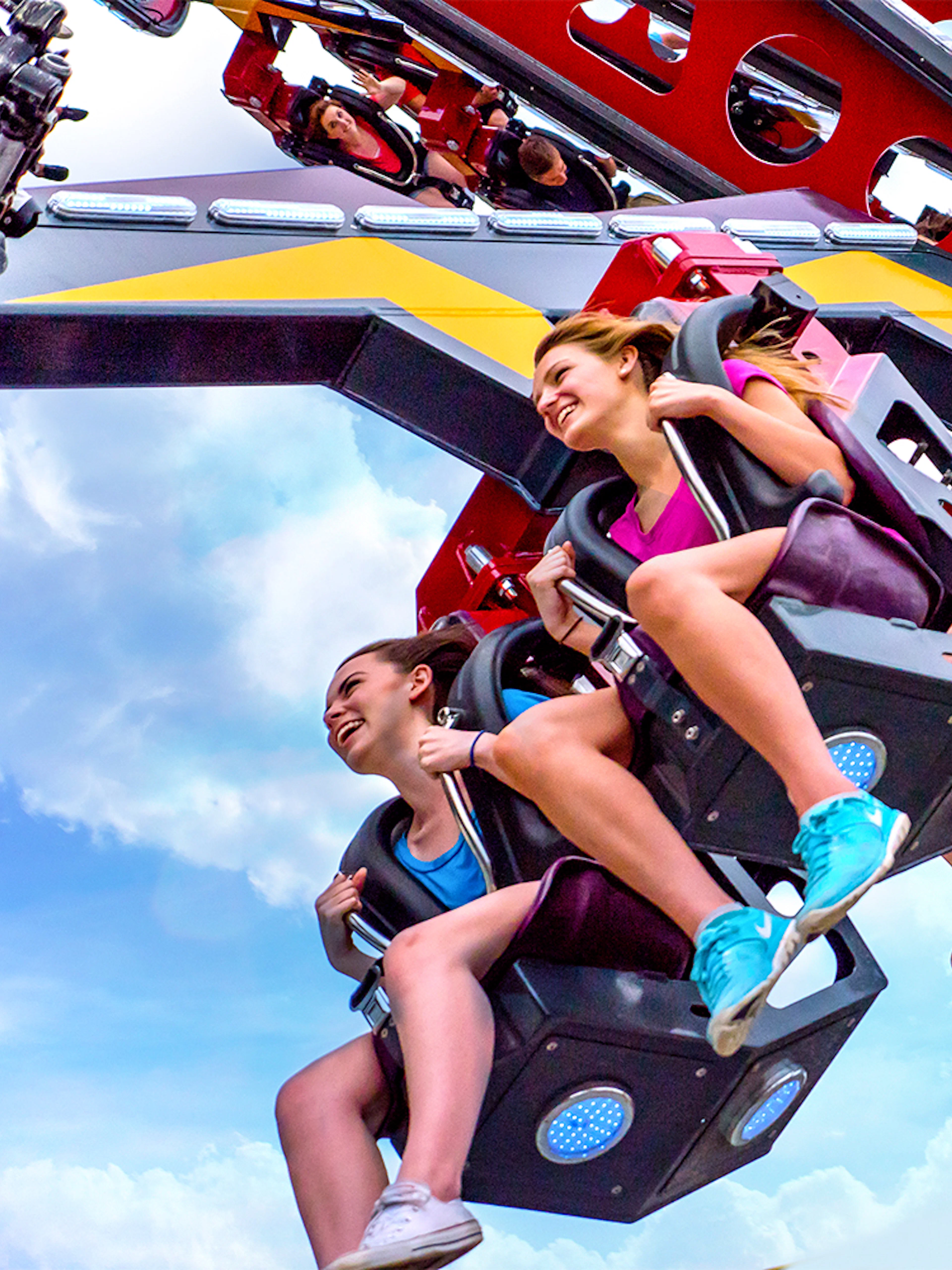 Riders enjoying the CATWOMAN™ Whip ride at Six Flags Over Texas.