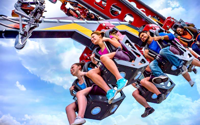 Riders enjoying the CATWOMAN™ Whip ride at Six Flags Over Texas.