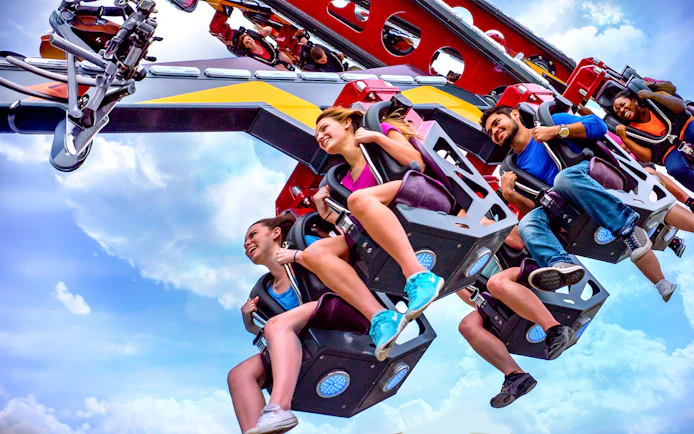 Riders enjoying the CATWOMAN™ Whip ride at Six Flags Over Texas.