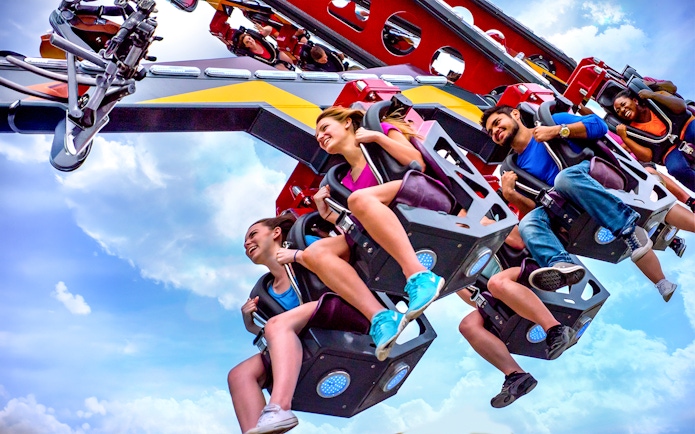Riders enjoying the CATWOMAN™ Whip ride at Six Flags Over Texas.