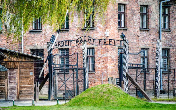 Auschwitz I entrance gate with "Arbeit Macht Frei" sign, Poland.