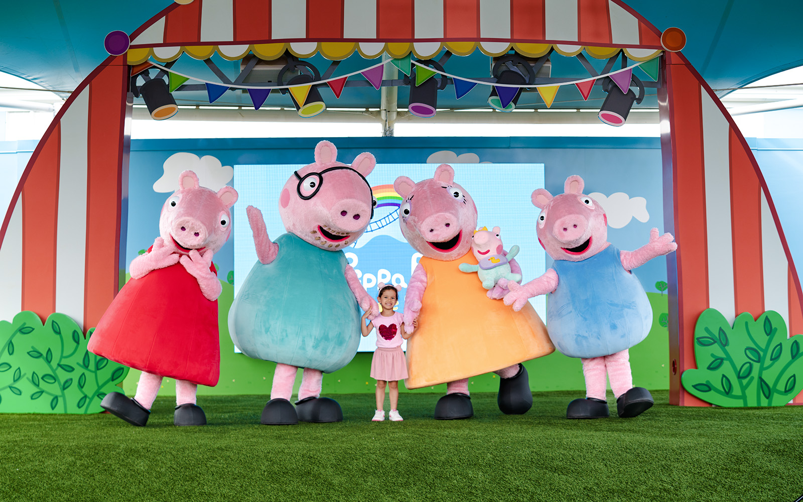 Peppa Pig characters with a child at Peppa Pig Theme Park, Florida.