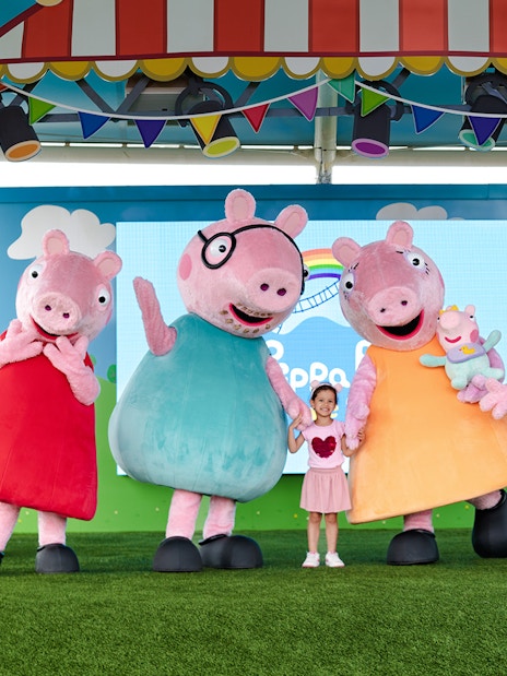 Peppa Pig characters with a child at Peppa Pig Theme Park, Florida.