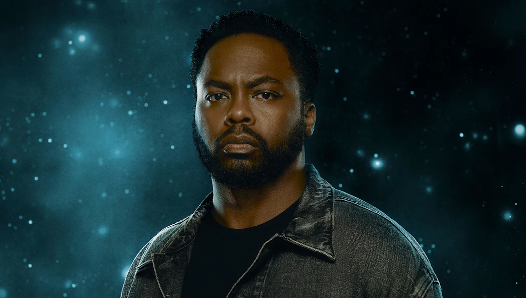 A person in a denim jacket against a starry background, related to "X: The Life and Times of Malcolm X.