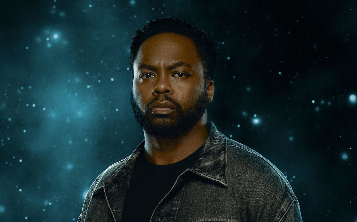 A person in a denim jacket against a starry background, related to "X: The Life and Times of Malcolm X.