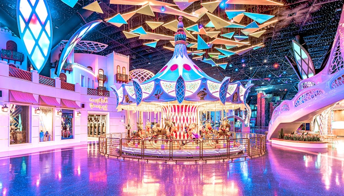 Carousel ride at Doha Quest Theme Park with vibrant lights and colorful decor.