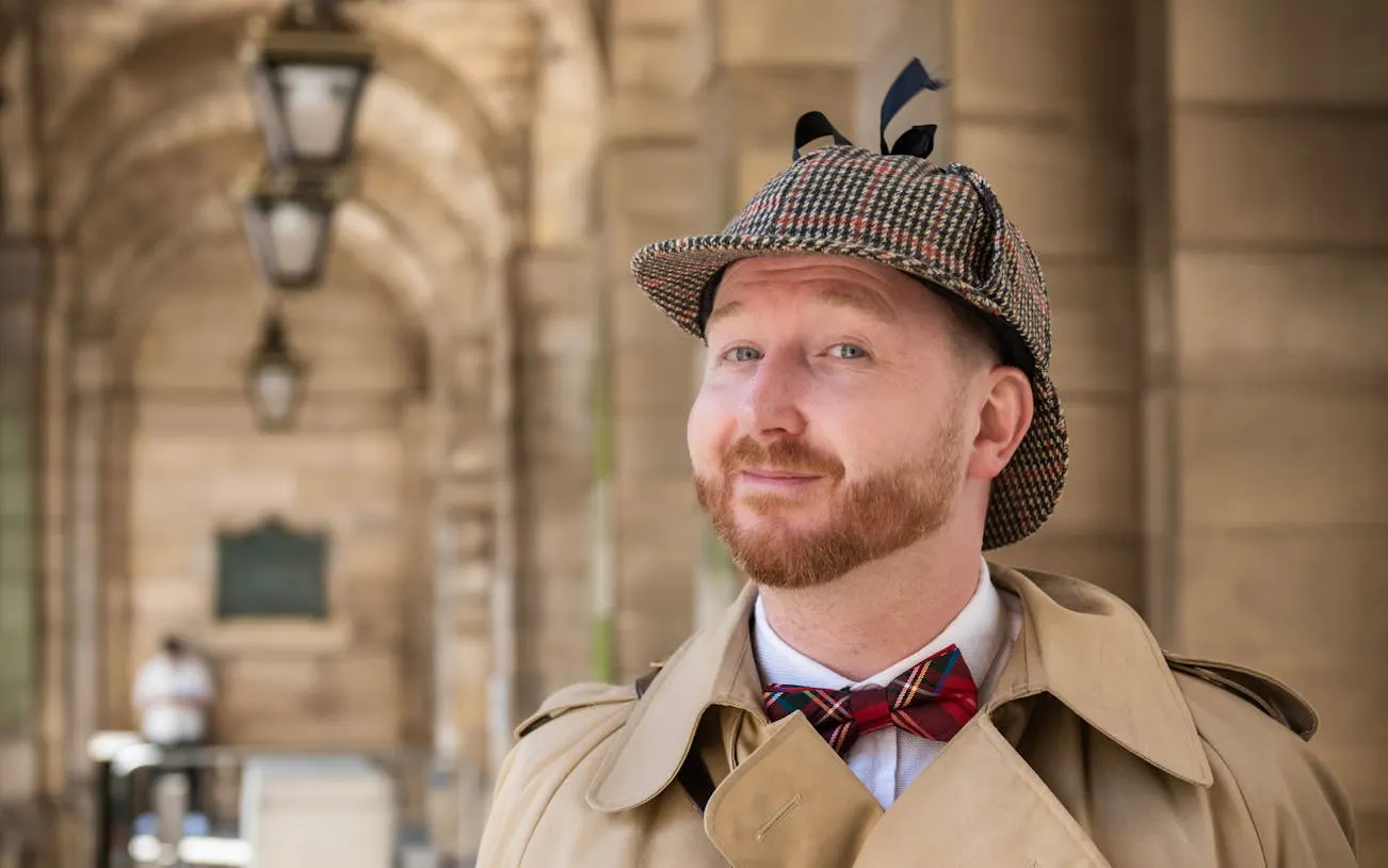 Man in traditional detective attire on Edinburgh Historical Gems Tour.