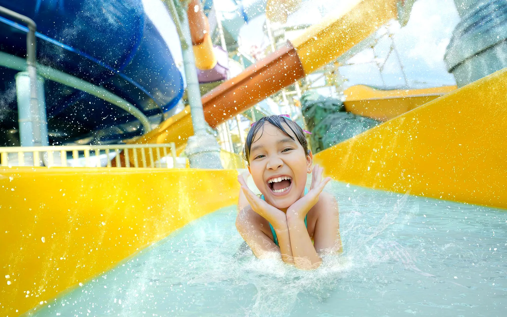 Kid enjoying water coaster at Atlantis Water Adventure Park Ancol.